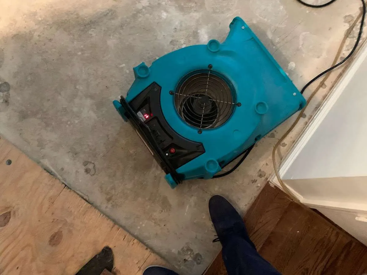 Air mover drying subfloor during Commercial Water Damage Restoration in Duluth